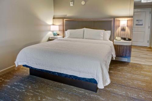 a bedroom with a large bed with two night stands at Hampton Inn & Suites Fort Myers Estero in Estero