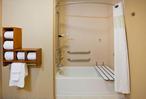 a bathroom with a tub and a shower with towels at Hampton Inn Fairmont in Fairmont