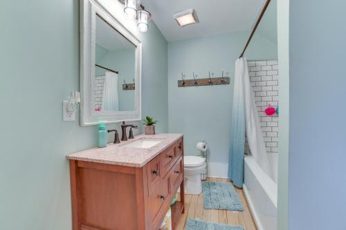 a bathroom with a sink and a toilet and a mirror at Cedar Creek Guesthouse 3 Mi to Lake Charlevoix in East Jordan