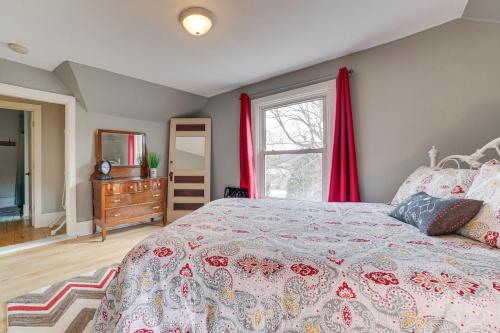 a bedroom with a bed and a window with red curtains at Cedar Creek Guesthouse 3 Mi to Lake Charlevoix in East Jordan