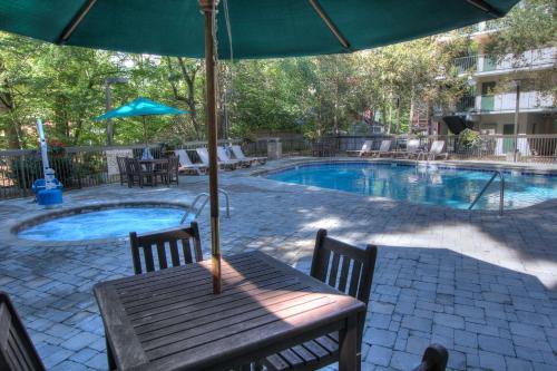 a table with an umbrella next to a swimming pool at Hampton Inn Gatlinburg in Gatlinburg