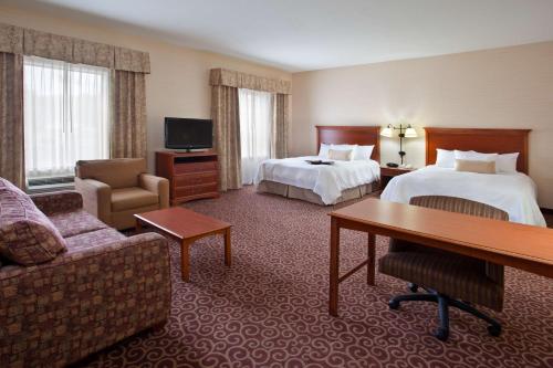 a hotel room with two beds and a desk at Hampton Inn & Suites Grove City in Grove City