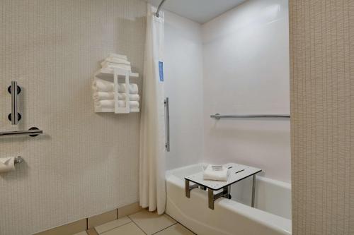 a bathroom with a tub and a toilet and a sink at Hampton Inn Greenwood in Greenwood