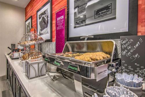 a bakery with a buffet with pastries and other food at Hampton Inn Houston NASA-Johnson Space Center in Seabrook