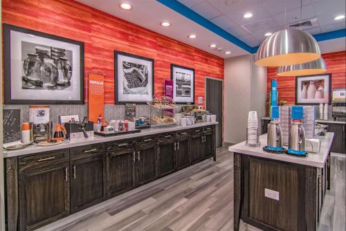 a beauty salon with wooden cabinets and a red wall at Hampton Inn Houston NASA-Johnson Space Center in Seabrook
