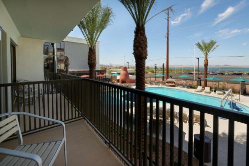 a balcony with a view of a pool and palm trees at Hampton Inn Lake Havasu City in Lake Havasu City