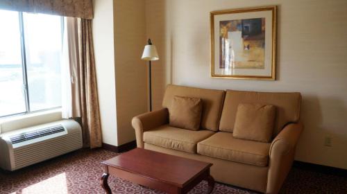 a living room with a couch and a table and a window at Hampton Inn & Suites Kingman in Kingman