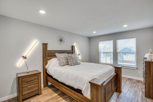 1 dormitorio con 1 cama de madera y 2 ventanas en Cedar Creek Reservoir Cabin Rental Near Boat Ramp!, en Malakoff