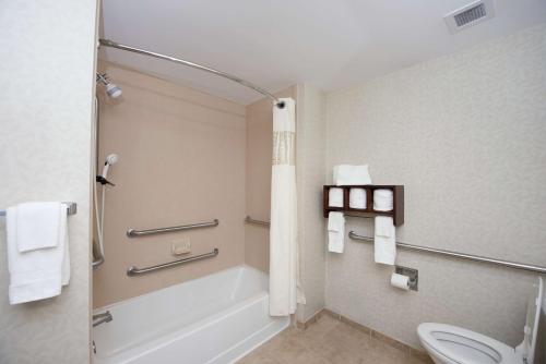 a bathroom with a bath tub and a toilet at Hampton Inn Yazoo City in Yazoo City