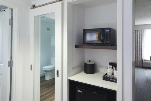 a bathroom with a microwave and a toilet at Hampton Inn Jasper in Jasper