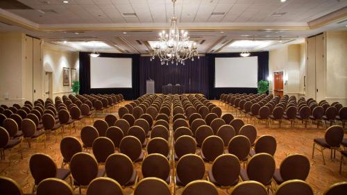 a large room with rows of chairs and a chandelier at DoubleTree by Hilton Sunrise - Sawgrass Mills in Sunrise