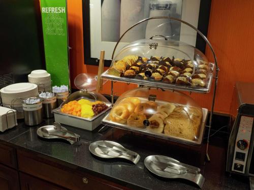a buffet line with trays of pastries and other food at Hampton Inn Hazleton in Hazleton
