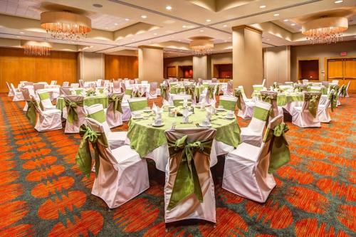 a banquet hall with white tables with green bows at Embassy Suites by Hilton Houston-Energy Corridor in Houston