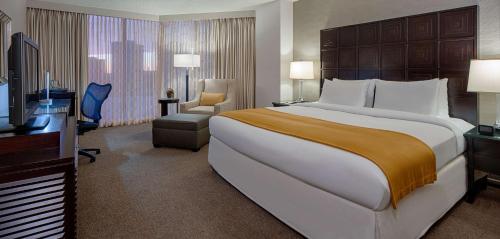 a hotel room with a large bed and a television at DoubleTree by Hilton Hotel Houston Greenway Plaza in Houston