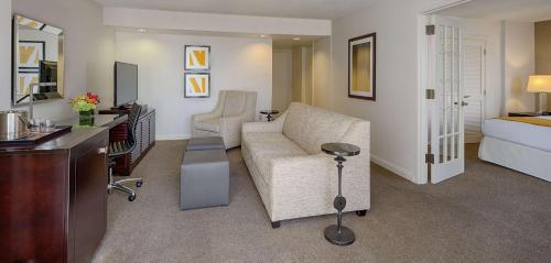 a living room with a couch and a bed at DoubleTree by Hilton Hotel Houston Greenway Plaza in Houston