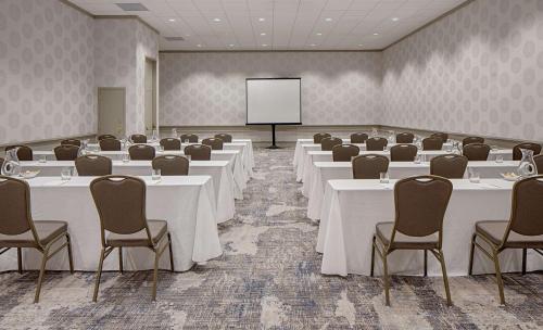 a conference room with tables and chairs and a screen at DoubleTree by Hilton Hotel Houston Greenway Plaza in Houston