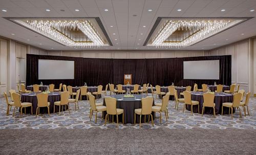a conference room with tables and chairs and screens at DoubleTree by Hilton Hotel Houston Greenway Plaza in Houston
