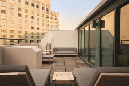 a balcony with a couch on a building at Embassy Suites by Hilton Indianapolis Downtown in Indianapolis