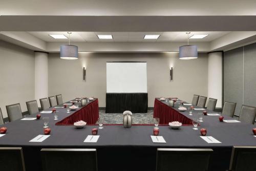 a conference room with a long table and chairs at Embassy Suites by Hilton Indianapolis Downtown in Indianapolis