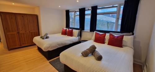 a room with two beds and a window at The Copper fields in London