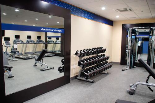 a gym with tread machines and a mirror at Hampton Inn Lebanon in Lebanon