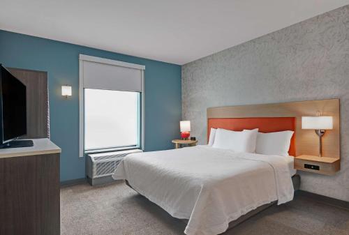 a bedroom with a large bed and a window at Home2 Suites By Hilton Bordentown in Bordentown