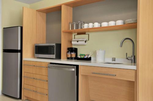 a kitchen with a stainless steel refrigerator and a microwave at Home2 Suites By Hilton Elko in Elko