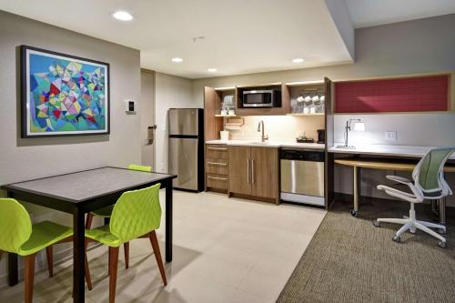 a kitchen with a table and chairs in a room at Home2 Suites By Hilton Frankfort in Frankfort