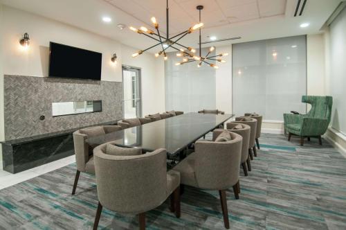 a conference room with a glass table and chairs at Hilton Garden Inn Jackson/Clinton in Clinton
