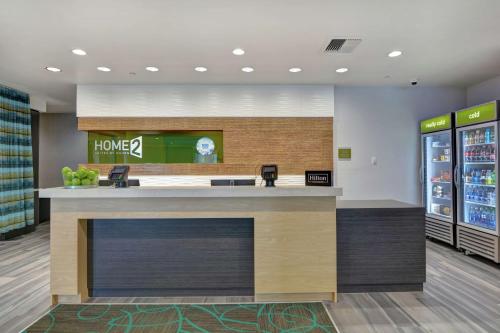 a home bar in a store with a drink at Home2 Suites By Hilton Springdale in Springdale