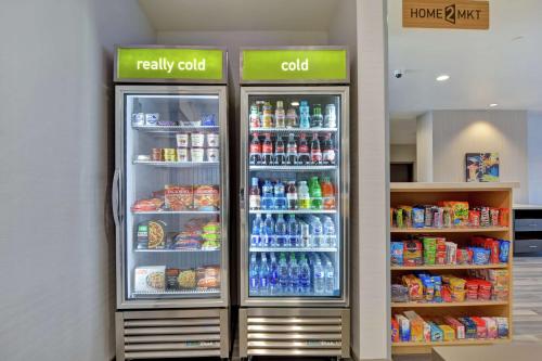 two refrigerators in a store with food and drinks at Home2 Suites By Hilton Springdale in Springdale