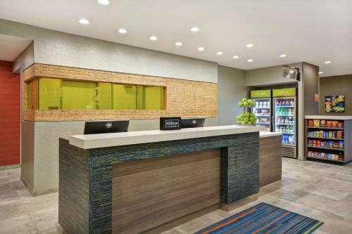 a lobby with a counter in a store at Home2 Suites Houston Westchase in Houston