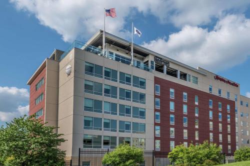 an office building with two american flags on top at Hampton Inn & Suites Fort Wayne Downtown in Fort Wayne