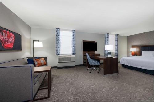 a hotel room with a bed and a desk at Hampton Inn & Suites Fort Wayne Downtown in Fort Wayne