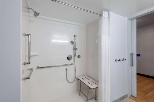 a white bathroom with a shower and a toilet at Hampton Inn & Suites Fort Wayne Downtown in Fort Wayne