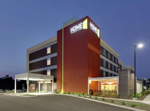 a large red building with a hotel sign on it at Home2 Suites By Hilton Hagerstown in Hagerstown