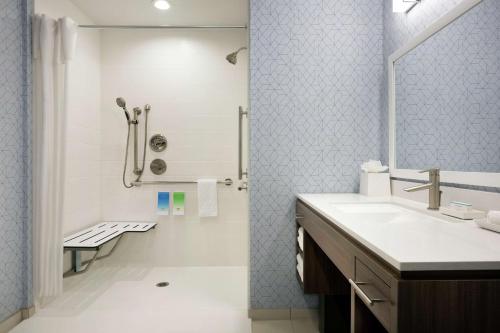 a bathroom with a sink and a shower at Home2 Suites By Hilton Houston-Pearland, Tx in Pearland