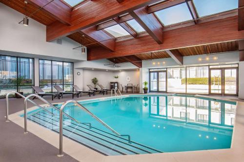 a swimming pool in a building with windows at DoubleTree by Hilton Washington DC North/Gaithersburg in Gaithersburg