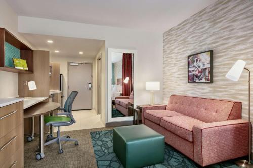 a hotel room with a couch and a desk and a bed at Home2 Suites By Hilton Easton in Easton