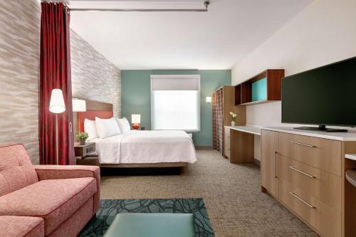 a hotel room with a bed and a television at Home2 Suites By Hilton Easton in Easton