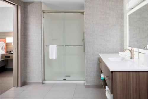 a bathroom with a shower with a glass door at Home2 Suites By Hilton Fort Wayne North in Sunnybrook Acres