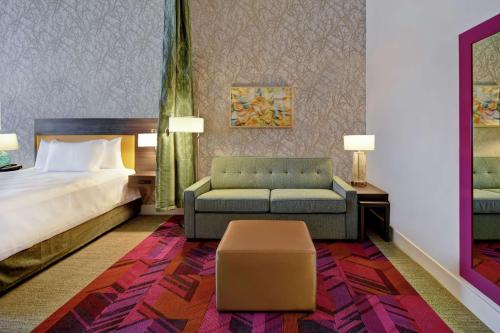 a hotel room with a bed and a couch at Home2 Suites by Hilton Wichita Northeast in Wichita