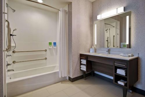 a bathroom with a tub and a sink and a shower at Home2 Suites by Hilton Wichita Northeast in Wichita