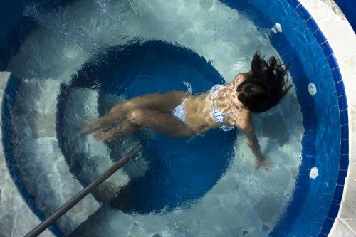 a woman in a swimming pool in the water at Saison Resort & Spa in Itaipava