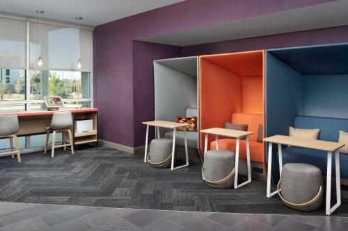 a room with tables and chairs and purple walls at Tru by Hilton Beaufort, Sc in Beaufort