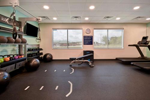 a gym with two treadmills and a treadmill at Tru By Hilton Auburn, In in Auburn
