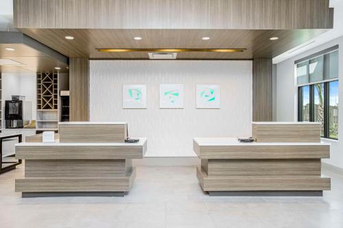 a lobby with three counters in a building at Hilton Garden Inn Harlingen Convention Center, Tx in Harlingen
