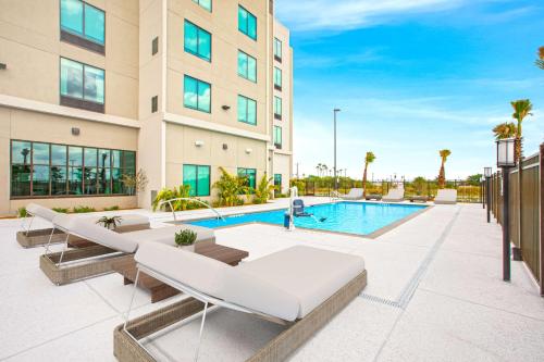an image of a swimming pool in a building at Hilton Garden Inn Harlingen Convention Center, Tx in Harlingen