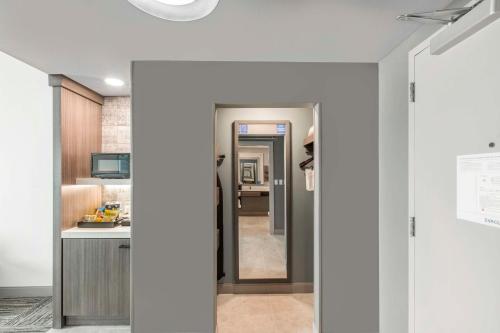a hallway leading into a kitchen with white walls at Hilton Garden Inn Harlingen Convention Center, Tx in Harlingen