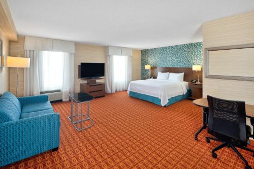 a large hotel room with a bed and a tv at Fairfield Inn & Suites by Marriott Toronto Airport in Mississauga